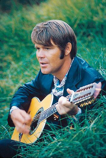 Glen using an Ovation 1118 Glen Campbell 12 for the '73 "I Knew Jesus" photo shoot